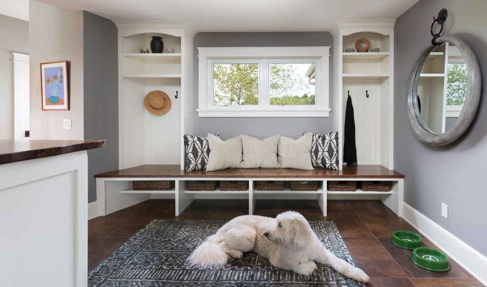 Entryway - large traditional brown floor and porcelain tile entryway idea in Milwaukee with gray walls