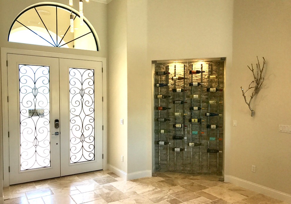 На фото: большая входная дверь в средиземноморском стиле с бежевыми стенами, полом из травертина, двустворчатой входной дверью, стеклянной входной дверью и коричневым полом