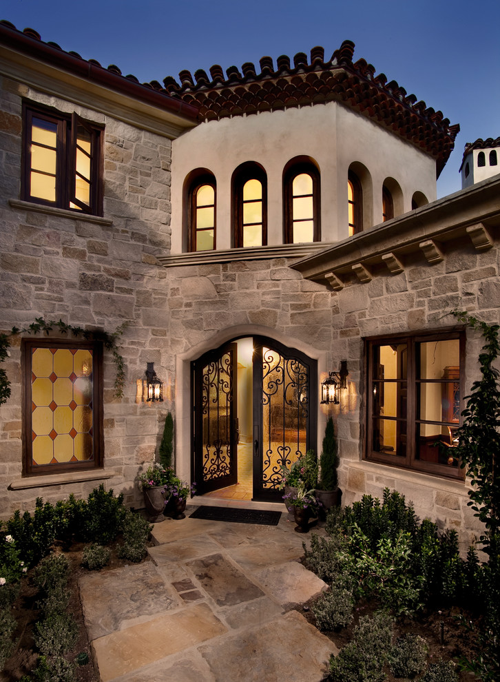 Inspiration for a mediterranean entryway remodel in San Diego with a metal front door