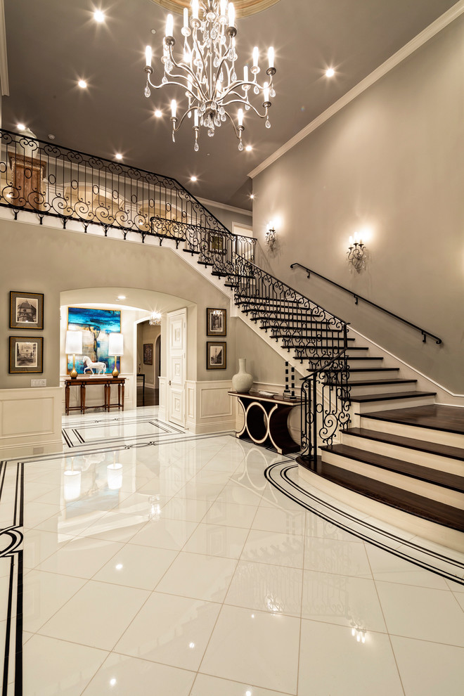 This is an example of a mediterranean foyer in Los Angeles with grey walls and white floors.