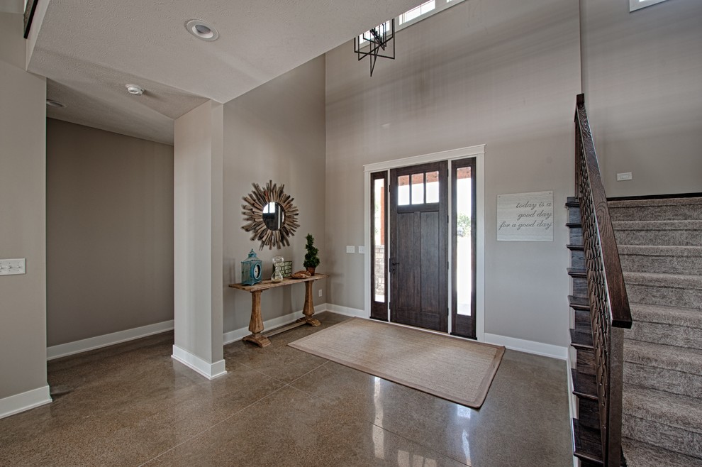 Inspiration for a mid-sized transitional concrete floor entryway remodel in Other with gray walls and a medium wood front door