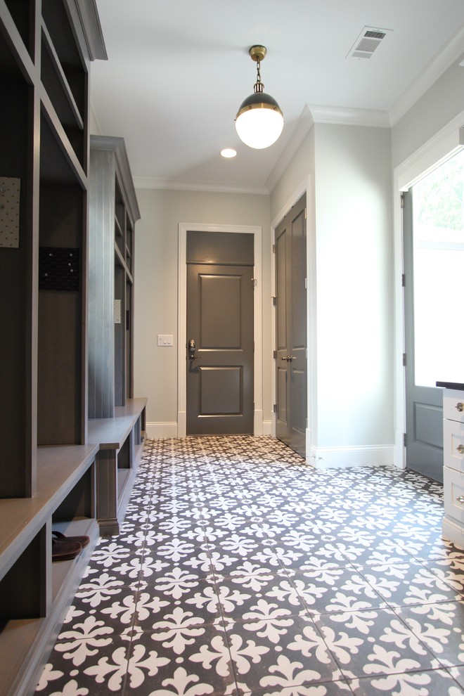 Design ideas for an expansive classic boot room in Atlanta with grey walls, porcelain flooring and a grey front door.