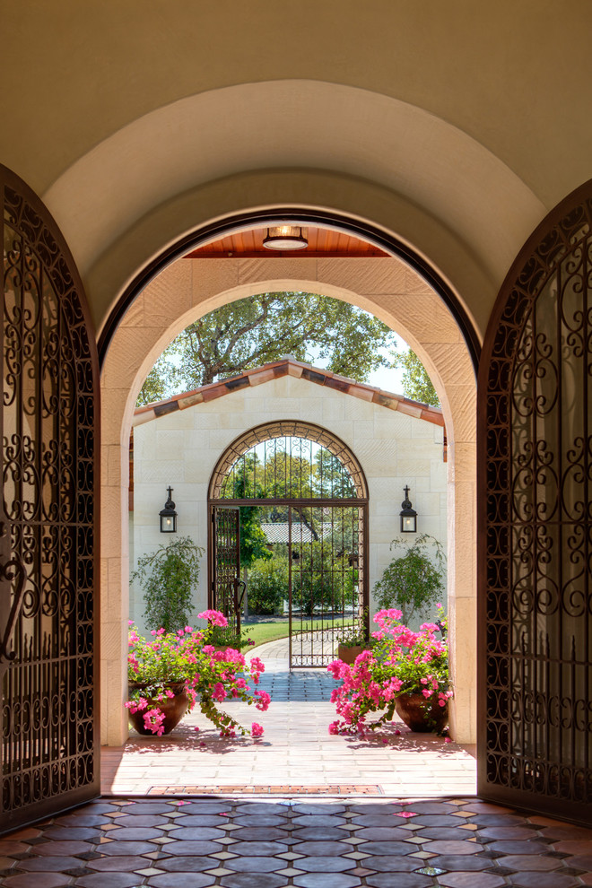Double front door - mediterranean double front door idea in Austin with a metal front door