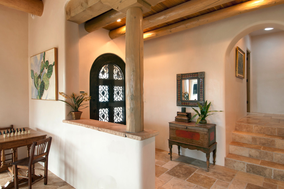 Mittelgroßes Mediterranes Foyer mit beiger Wandfarbe, Travertin, Einzeltür und dunkler Holzhaustür in Albuquerque