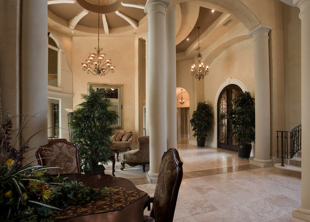 Example of a huge tuscan ceramic tile entryway design in Miami with beige walls and a brown front door