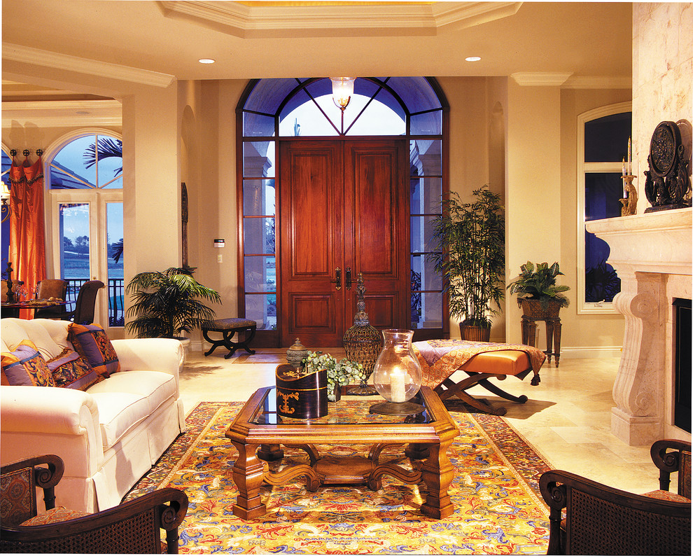 Large elegant travertine floor entryway photo in Miami with beige walls and a dark wood front door