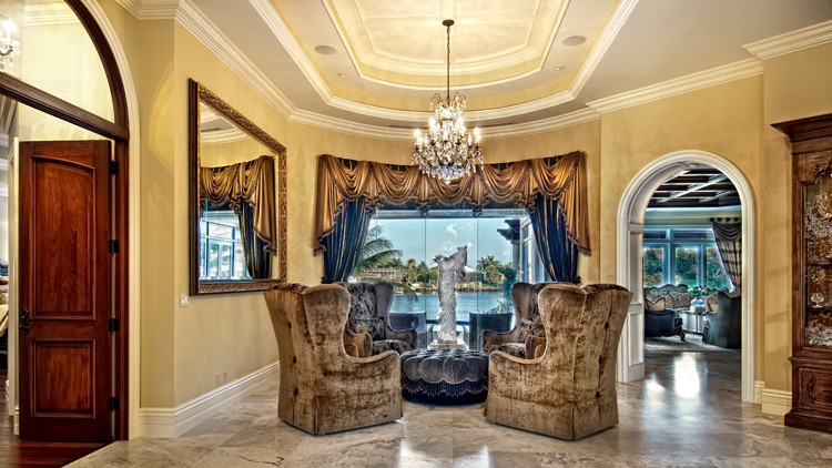 Photo of a large mediterranean foyer in Miami with beige walls, travertine flooring, a double front door and a dark wood front door.