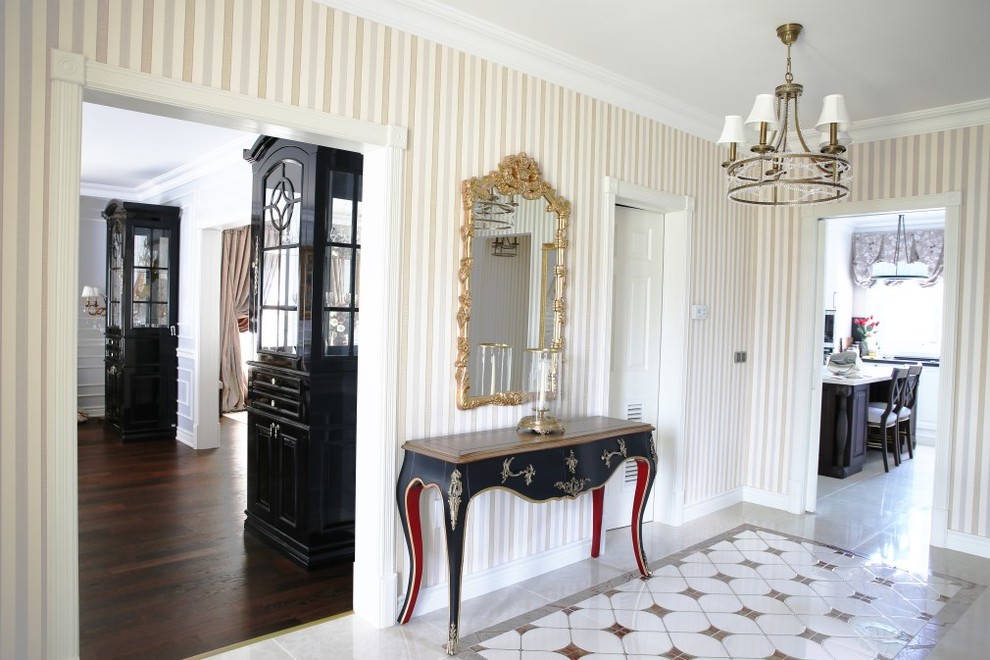 This is an example of a large classic hallway in Other with multi-coloured walls, marble flooring, a double front door and a white front door.