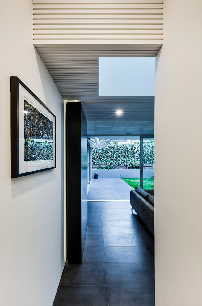 Inspiration for a contemporary entrance in Sydney with white walls.