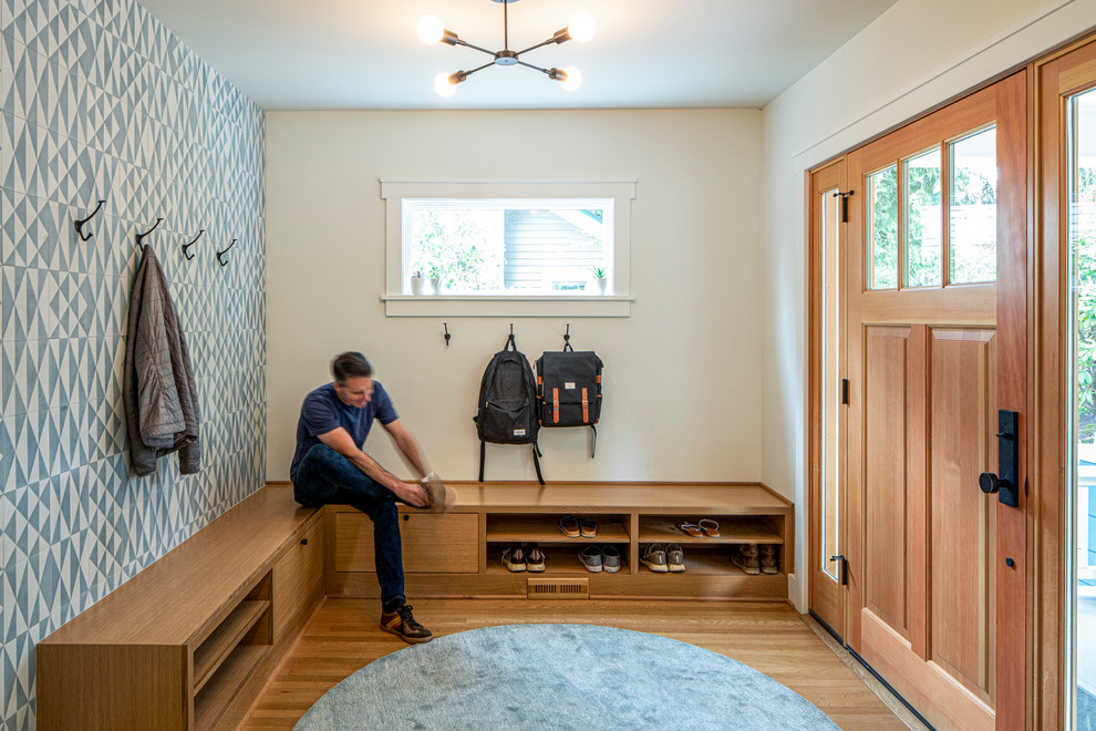 Transitional light wood floor entryway photo in Portland with multicolored walls and a light wood front door