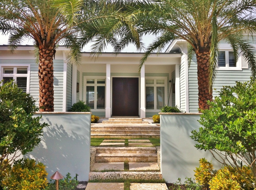World-inspired entrance in Miami with a double front door and a dark wood front door.
