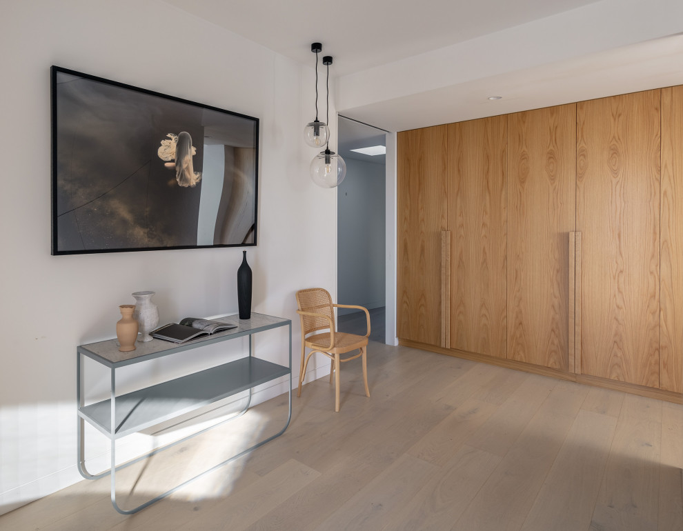 Vestibule - large contemporary light wood floor vestibule idea in Sydney with white walls and a medium wood front door