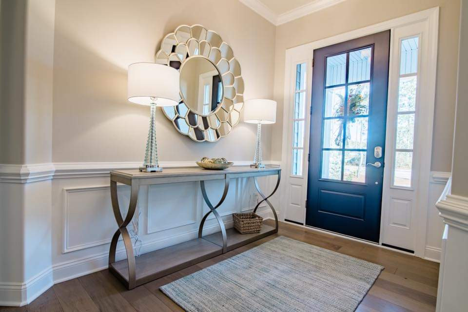 Inspiration for a mid-sized coastal medium tone wood floor and brown floor entryway remodel with beige walls and a glass front door