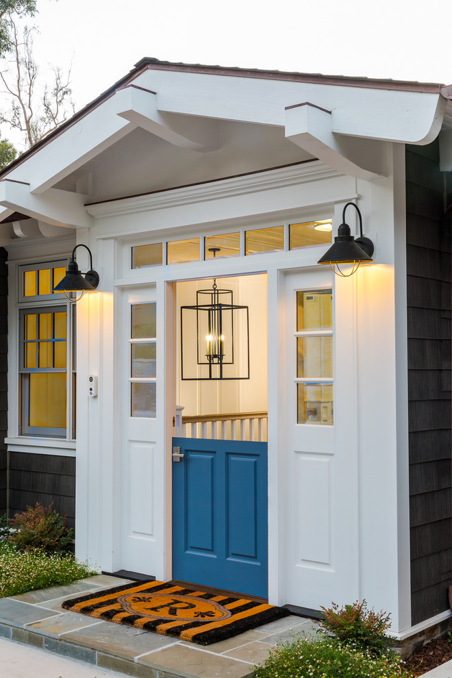 Example of a mid-sized beach style granite floor and gray floor entryway design in San Diego with gray walls and a blue front door