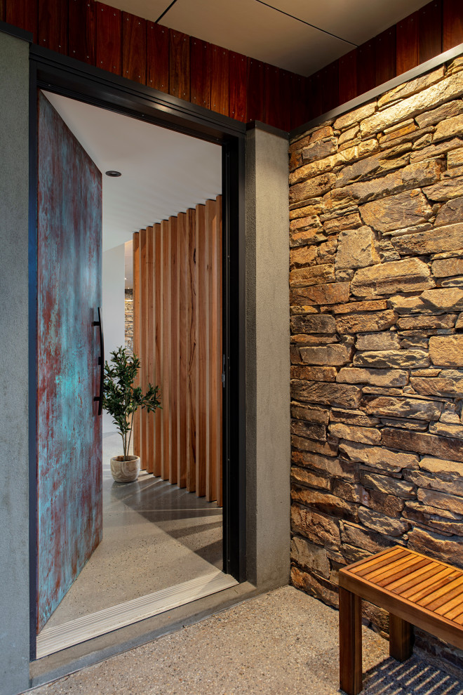 Cette image montre une porte d'entrée vintage de taille moyenne avec sol en béton ciré, une porte simple, une porte métallisée et un sol gris.