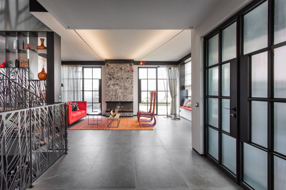 Mid-sized urban porcelain tile and gray floor entryway photo in Tel Aviv with black walls and a glass front door