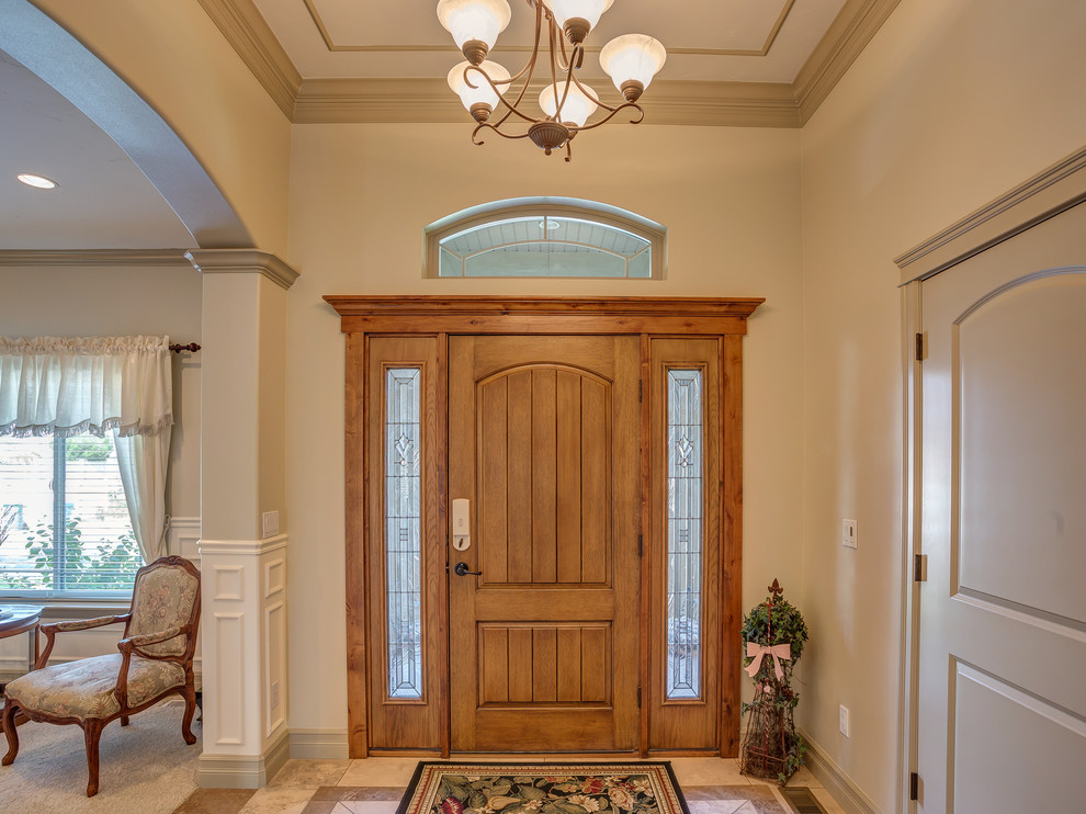 Inspiration for a medium sized traditional foyer in Salt Lake City with white walls, ceramic flooring, a single front door and a medium wood front door.