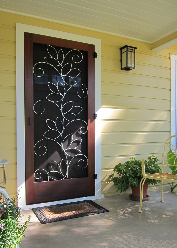 Photo of a traditional front door in Austin with white walls, concrete flooring, a single front door and a dark wood front door.