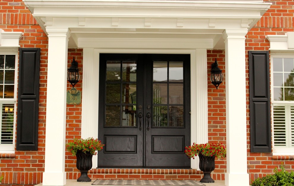 Cette photo montre une porte d'entrée chic de taille moyenne avec sol en béton ciré, une porte double et une porte noire.