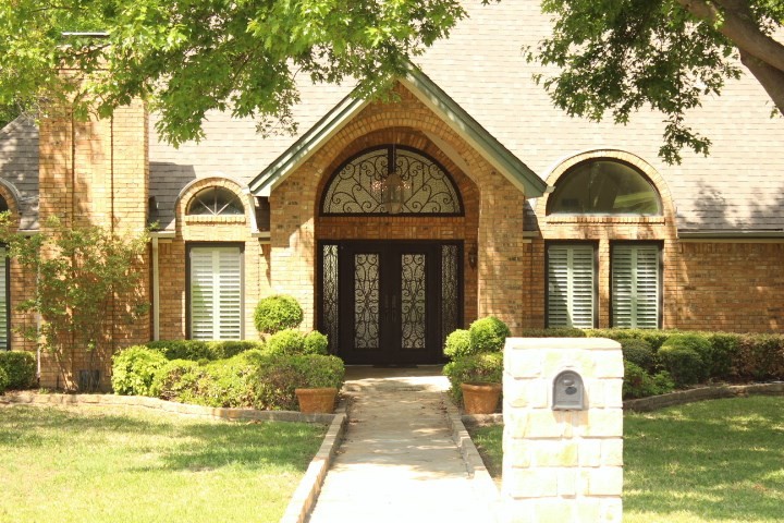 Example of a large entryway design in Dallas with a metal front door