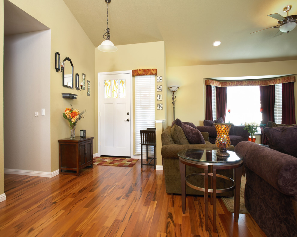 Example of a mid-sized cottage chic medium tone wood floor entryway design in Sacramento with beige walls and a glass front door