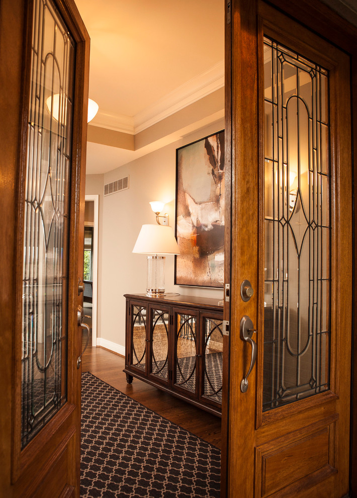 Entryway - large transitional dark wood floor entryway idea in Cincinnati with gray walls and a glass front door