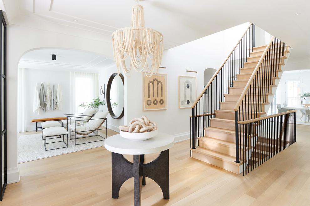 Inspiration for a nautical foyer in New York with white walls, light hardwood flooring and beige floors.
