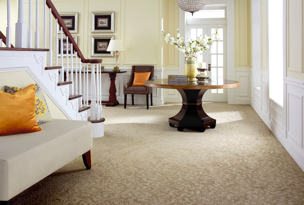 Entryway - mid-sized traditional carpeted and beige floor entryway idea in Houston with yellow walls and a white front door