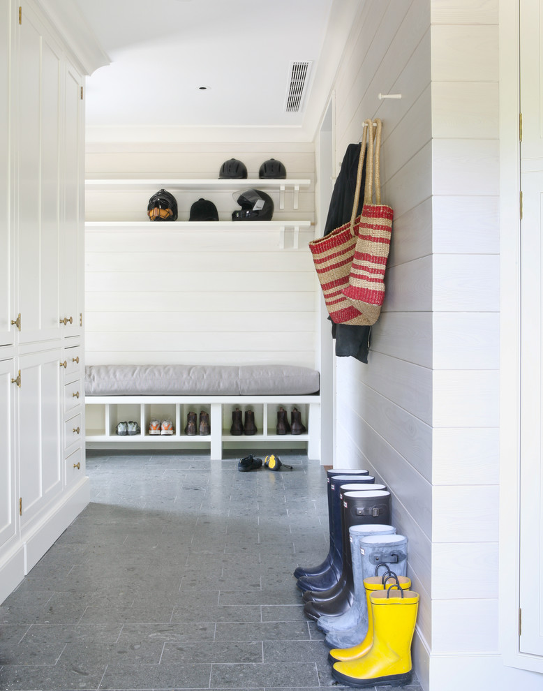 Inspiration for a coastal gray floor mudroom remodel in New York with white walls
