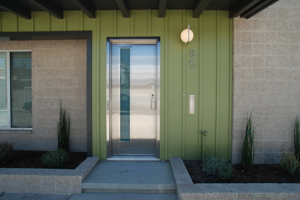 Midcentury entrance in Los Angeles with a single front door and a metal front door.