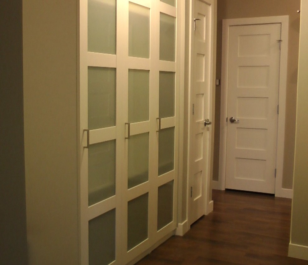Example of a mid-sized transitional dark wood floor entryway design in Calgary with beige walls