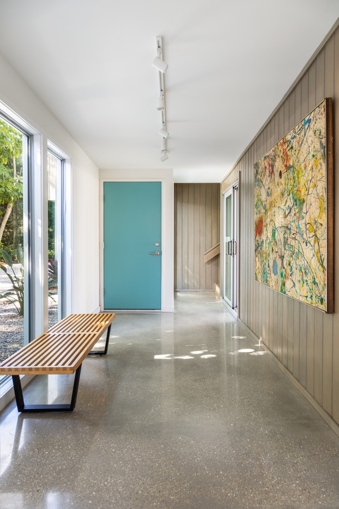 タンパにある中くらいなミッドセンチュリースタイルのおしゃれな玄関ホール (ベージュの壁、コンクリートの床、緑のドア、グレーの床) の写真