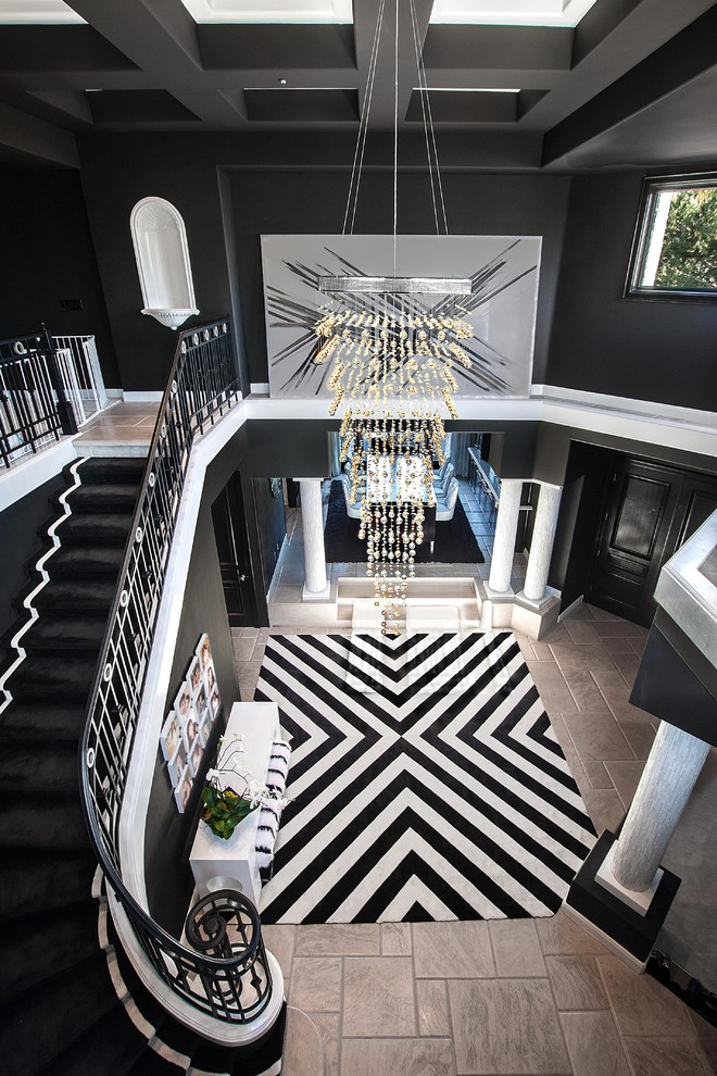Design ideas for a contemporary foyer in Orange County with black walls and grey floors.