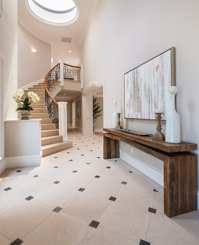 Entryway - large contemporary marble floor and beige floor entryway idea in Sacramento with gray walls and a glass front door