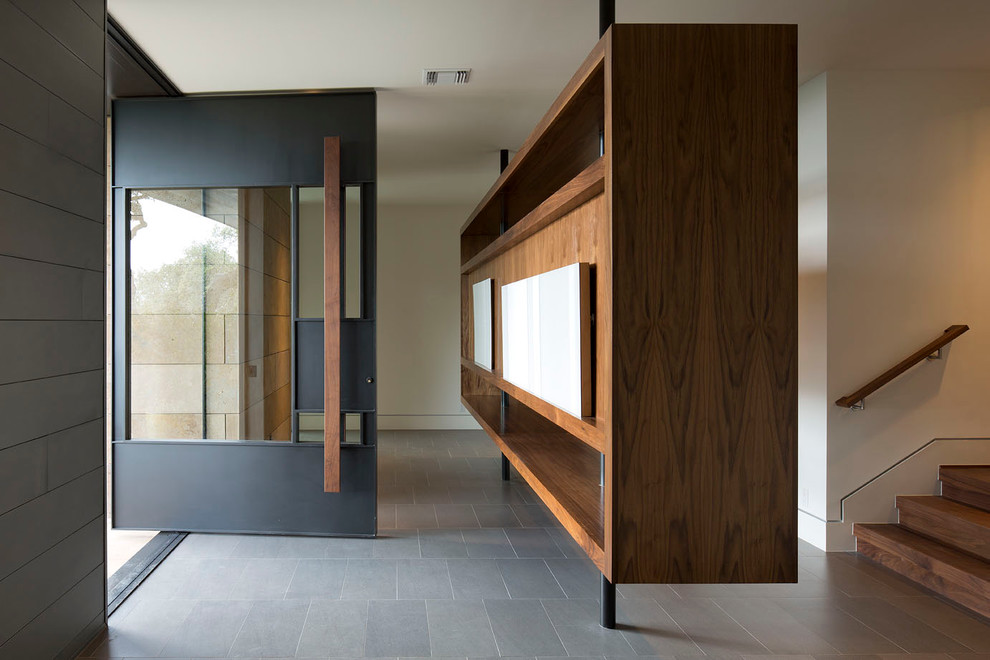 Inspiration for a contemporary foyer in Austin with white walls, a pivot front door and a glass front door.
