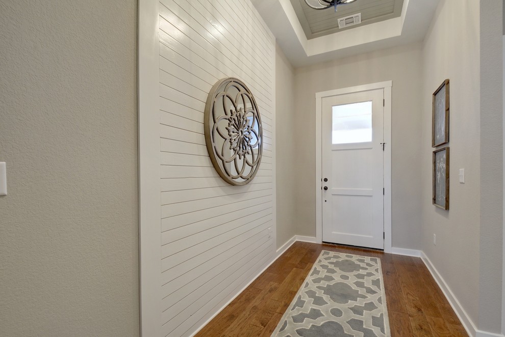 Klassisches Foyer mit grauer Wandfarbe, braunem Holzboden, Einzeltür, weißer Haustür und braunem Boden in Jacksonville