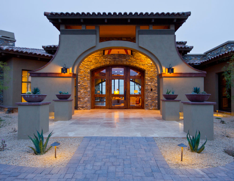 Tuscan entryway photo in Phoenix with a glass front door