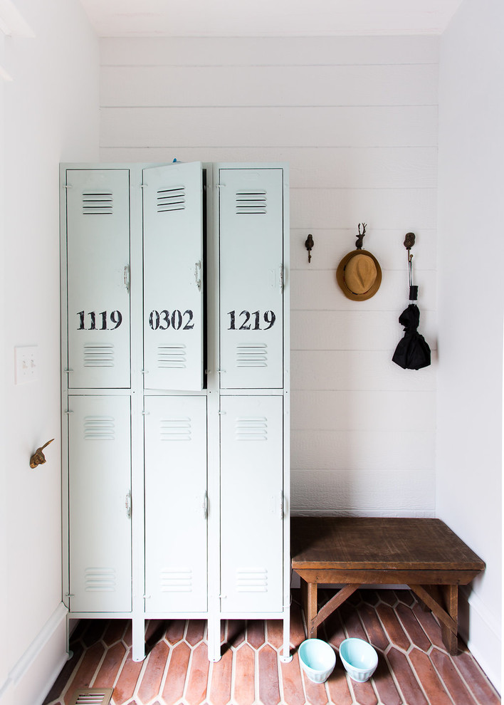 Design ideas for a farmhouse boot room in Chicago with white walls, terracotta flooring and red floors.