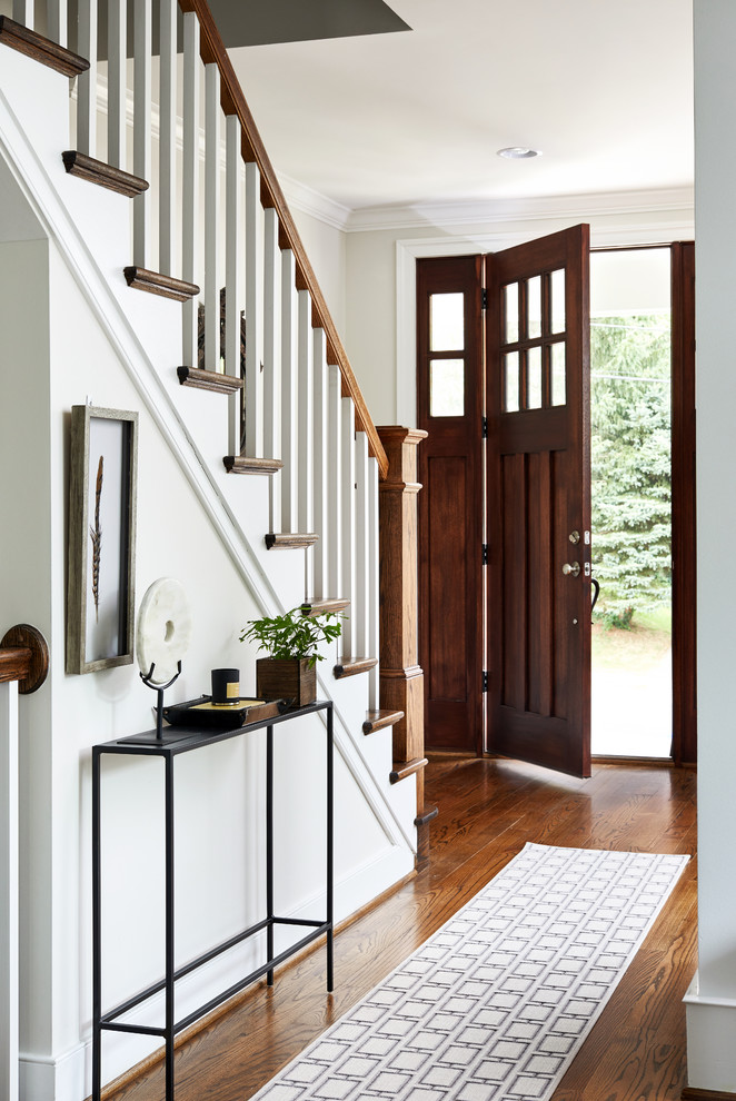 Inspiration for a mid-sized transitional brown floor and dark wood floor entryway remodel in DC Metro with beige walls and a dark wood front door
