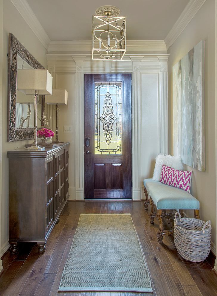 Inspiration for a mid-sized timeless medium tone wood floor and brown floor single front door remodel in Other with a dark wood front door and black walls