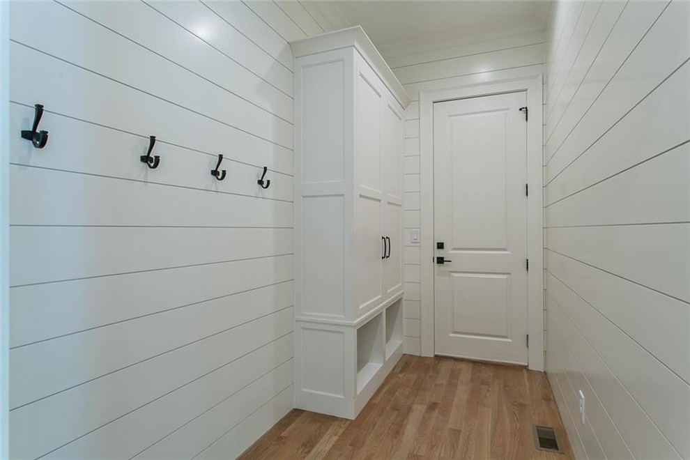 Inspiration for a mid-sized light wood floor and gray floor mudroom remodel in Atlanta with white walls