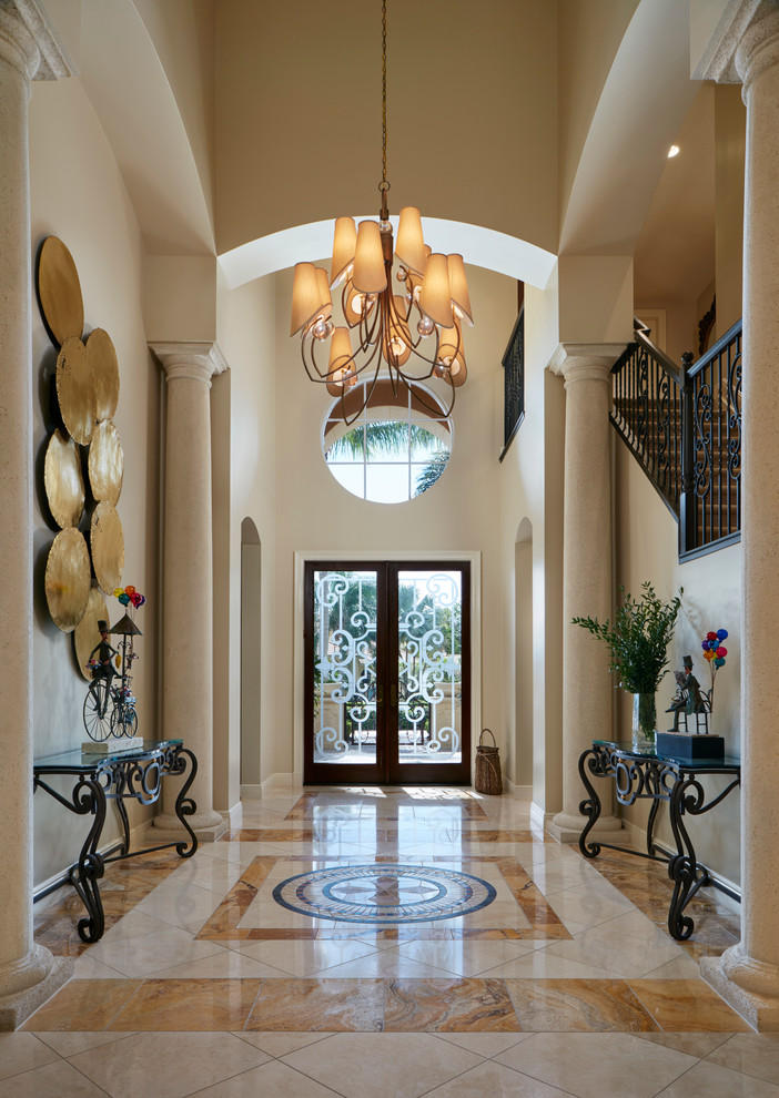 Design ideas for a large classic foyer in Miami with beige walls, porcelain flooring, a double front door and a dark wood front door.