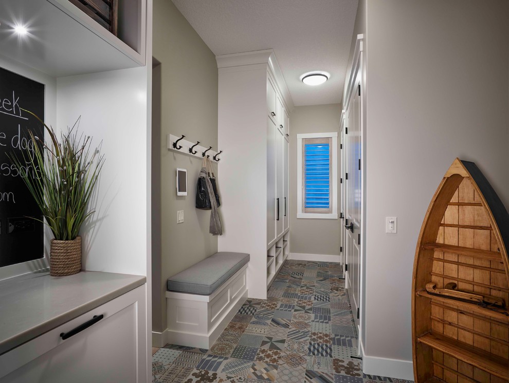 Mid-sized beach style ceramic tile mudroom photo in Calgary with beige walls