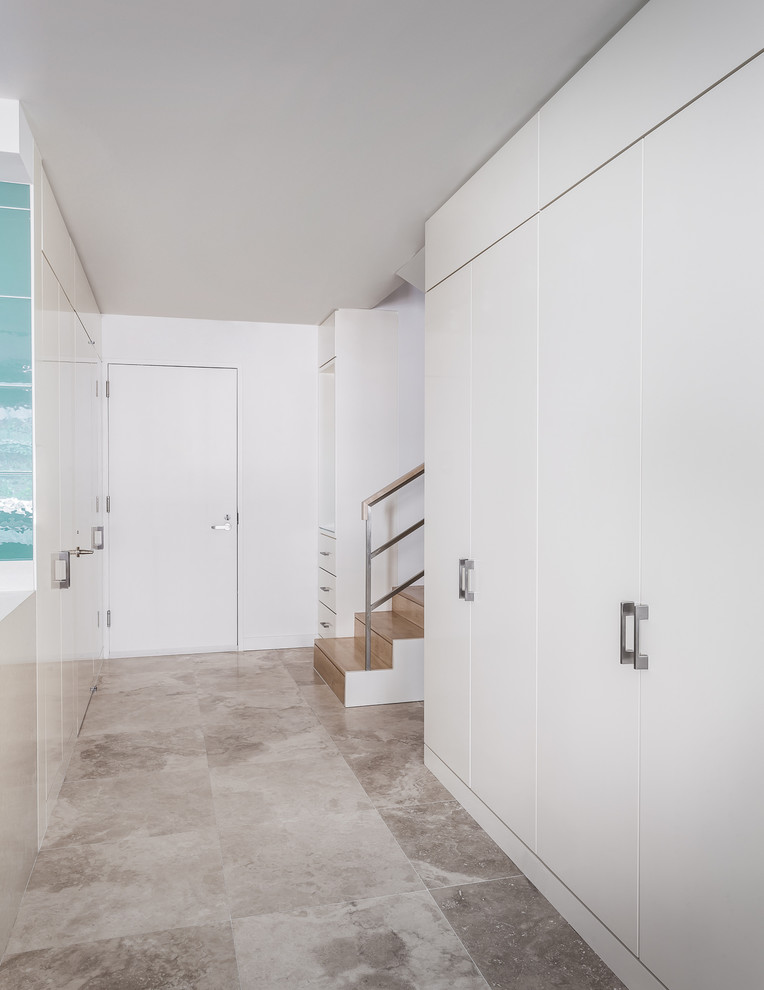 Design ideas for a medium sized modern hallway in New York with white walls, travertine flooring, a single front door and a white front door.