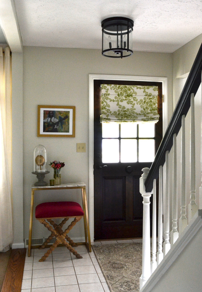 Entryway - small eclectic entryway idea in Houston with gray walls and a dark wood front door