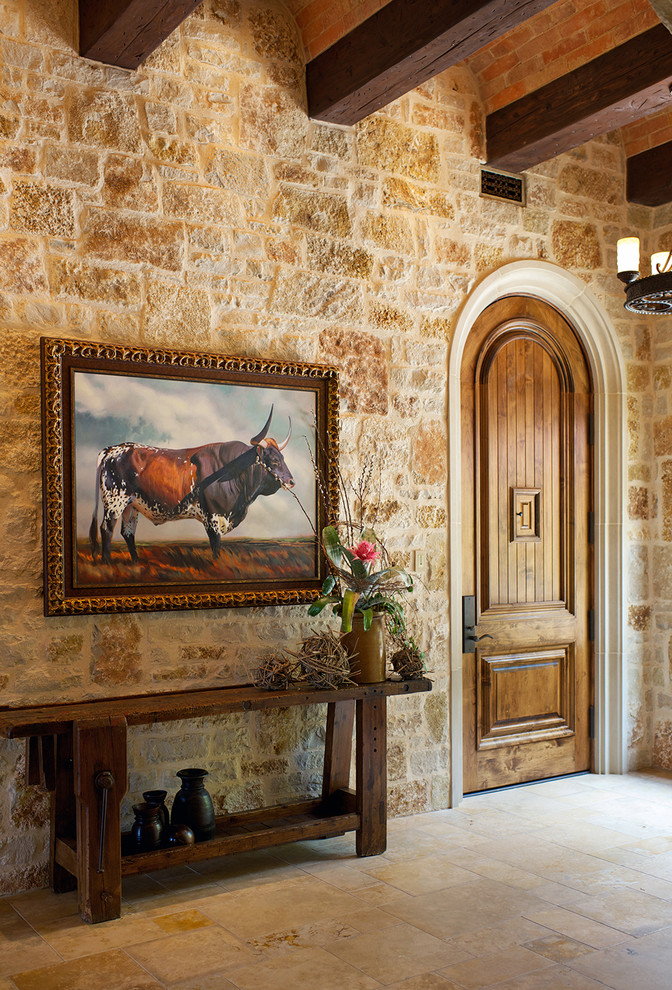 Mid-sized limestone floor entryway photo in Dallas with beige walls and a medium wood front door