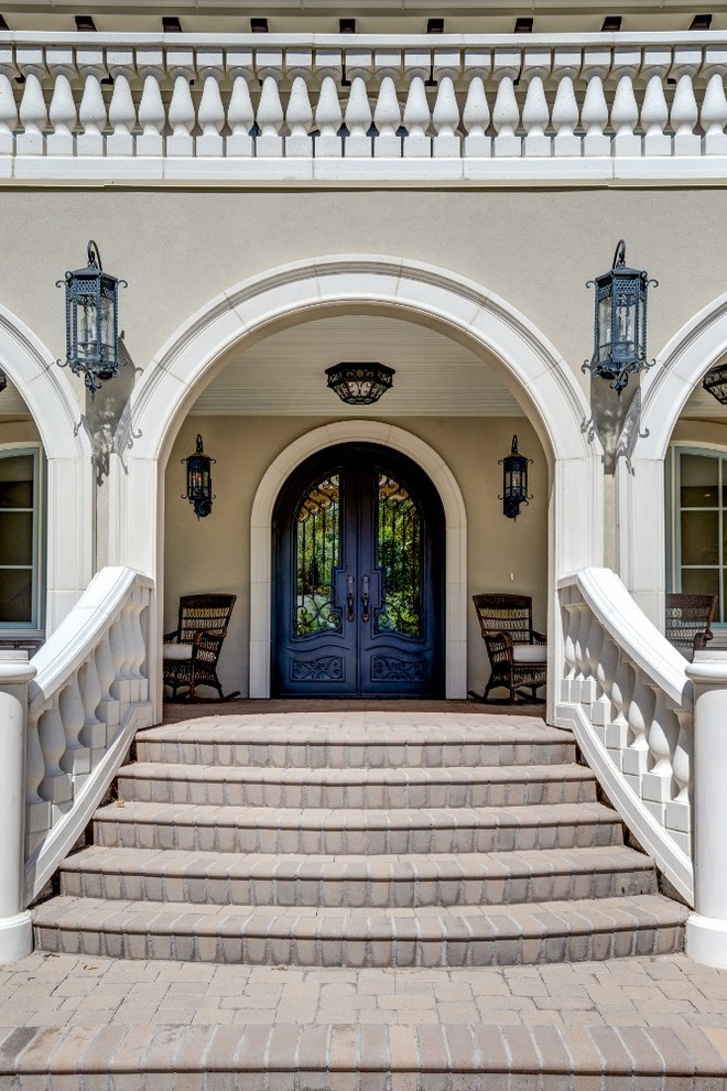 Idée de décoration pour une grande porte d'entrée tradition avec un mur beige, une porte double et une porte métallisée.