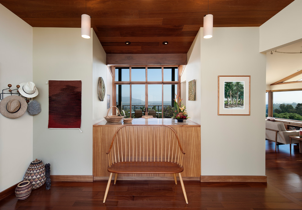 Inspiration for a mid-century modern dark wood floor foyer remodel in Santa Barbara with white walls