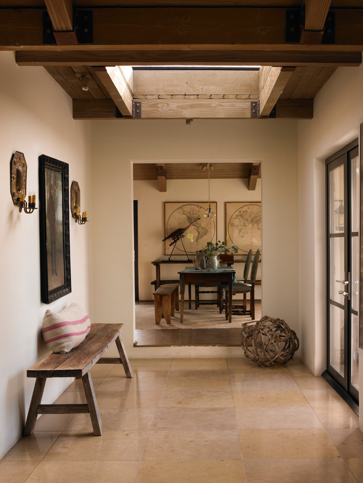 Photo of a mediterranean foyer in Los Angeles with white walls and a double front door.
