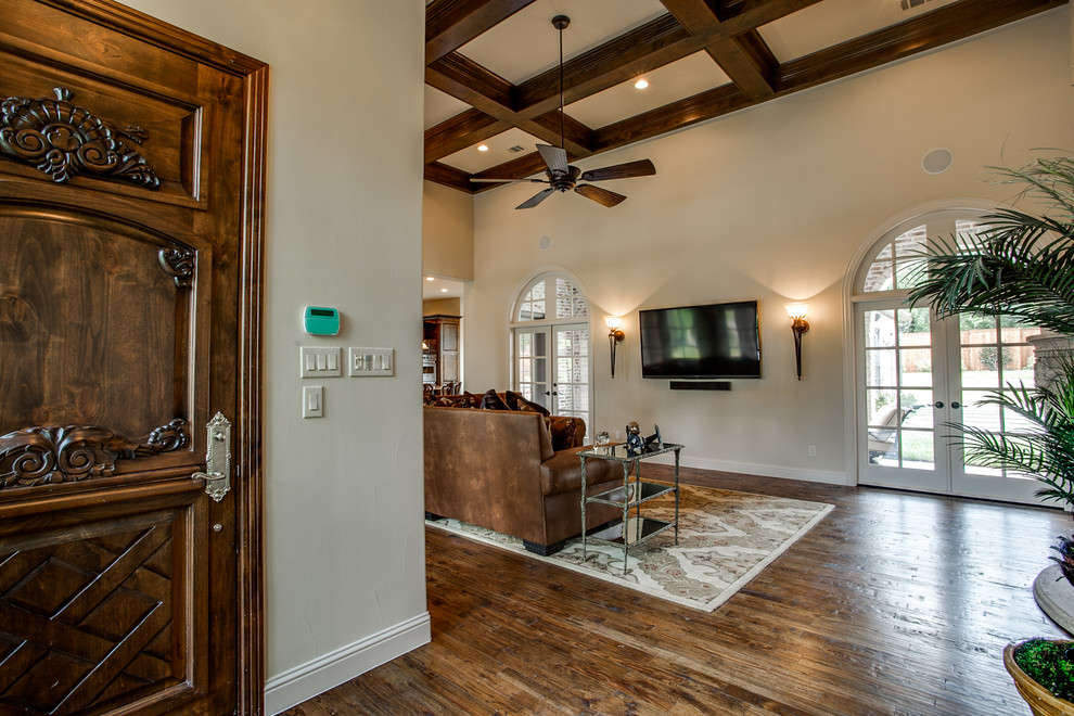 Example of a large tuscan medium tone wood floor entryway design in Austin with white walls and a medium wood front door